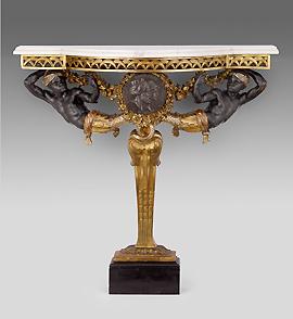 Marble table with male figure supports on a gold base.