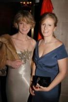 Two women in evening gowns at an event