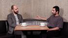 video still of Xavier Salomon and Salman Toor seated at table, talking