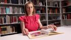 video thumbnail of woman looking at open book in library