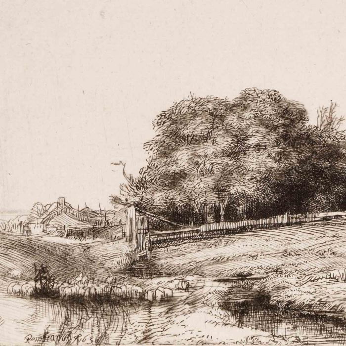 a hay barn surrounded by trees 