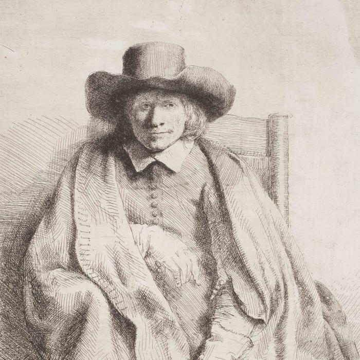 portrait of a man seated in a wooden chair wearing a large hat 