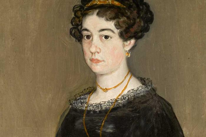 portrait of woman with dark curly hair in black dress