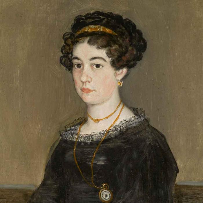 portrait of woman with dark curly hair in black dress