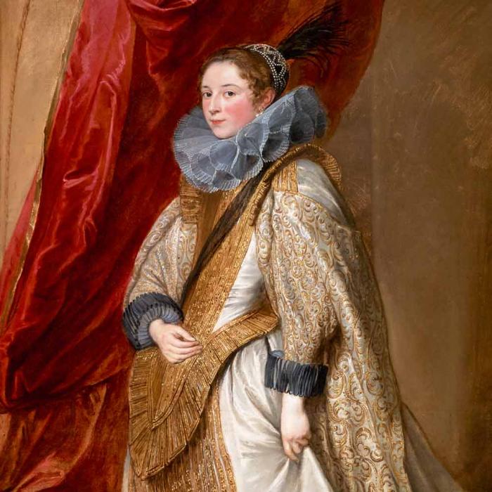 portrait of a woman in white and gold dress and red curtain in the background