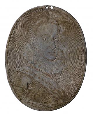 Silver portrait medal of Charles, Prince of Wales hair worn short, in a lace ruff, armor, and with a sash across his chest, beneath which is visible the medal of the Order of the Garter, suspended from a ribbon