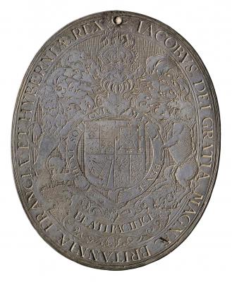 Silver medal of the Shield of Britain, framed by the Garter, with helmet, crest, and lion and unicorn supporters