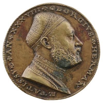 Bronze medal of a man wearing a padded calotte cap