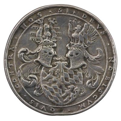 Silver medal depicting two helmets on either side of a quartered shield