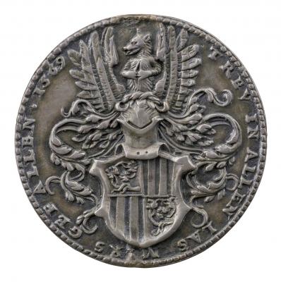 Silver medal depicting a plumed helmet above a shield