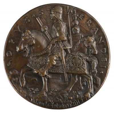 Bronze medal of a man wearing armor and a round hat, carrying a staff in his right hand, with a sword at his belt, on horseback, in profile to the left. Another man in armor on horseback is visible behind him