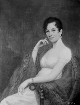 Half-length portrait of a young woman dressed in a short-sleeved white dress and a shawl in a chair.