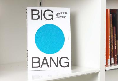 Book on a white shelf featuring the words "Big Bang" and a large glittery blue circle in the center