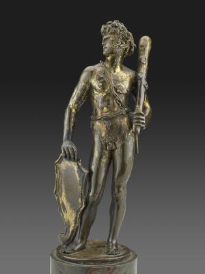statue of man holding shield and club