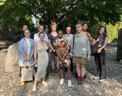 Group posing for a photo in a sculpture garden