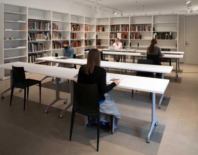 Library users sitting at desks in a reading room