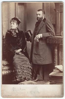 Black-and-white photograph of an elegant young couple, the man and woman both looking to their right