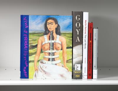 Five books with one cover showing a portrait of Frida Kahlo in white back braces, her spine visible