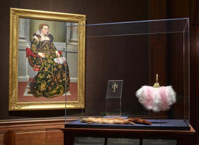 A framed portrait of woman sitting and the marten with a jeweled head and fan