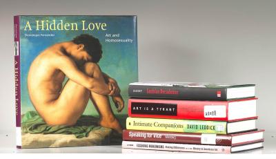 Book stack next to a book cover entitled "A Hidden Love" featuring an artwork of a nude male figure