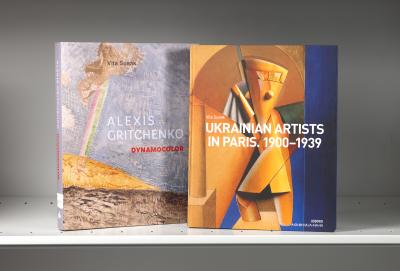 Two books on a shelf with covers featuring blue-and-yellow artworks