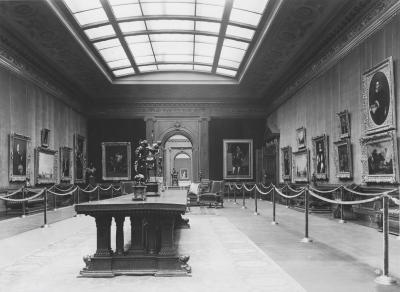 Historical photo of the Frick's West Gallery, 1935, with roped stanchions lining the walls