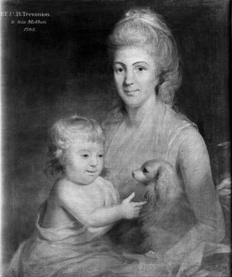 A woman holding a young child and a small spaniel on her lap.