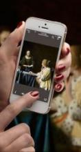 close up shot of hand holding iphone using the Frick Collection app