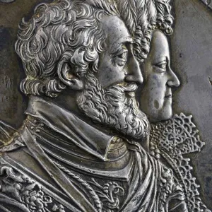 detail of medal depicting bearded man and woman in profile