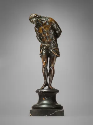 Bronze sculpture of standing man.