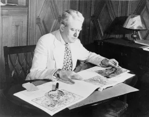 William Dinsmoor seated in library, circa 1943-1945
